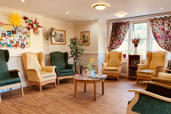 Comfortable single bedroom with flowers and art at Parkview Nursing Home